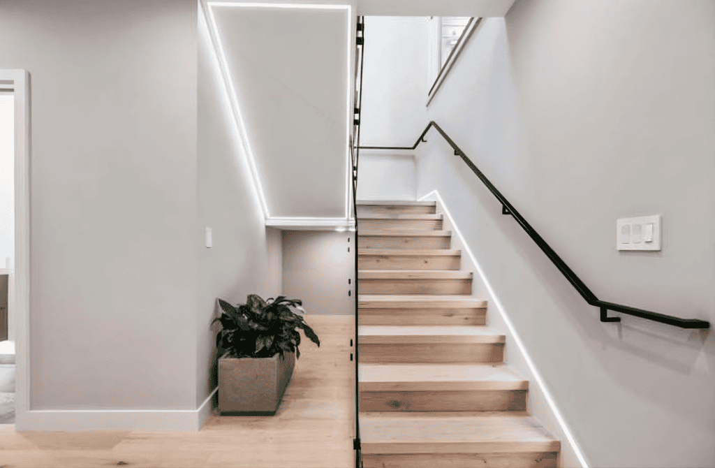 Newly built staircase with frameless glass railing in Saratoga whole home renovation By California Bay builders & Remodeling