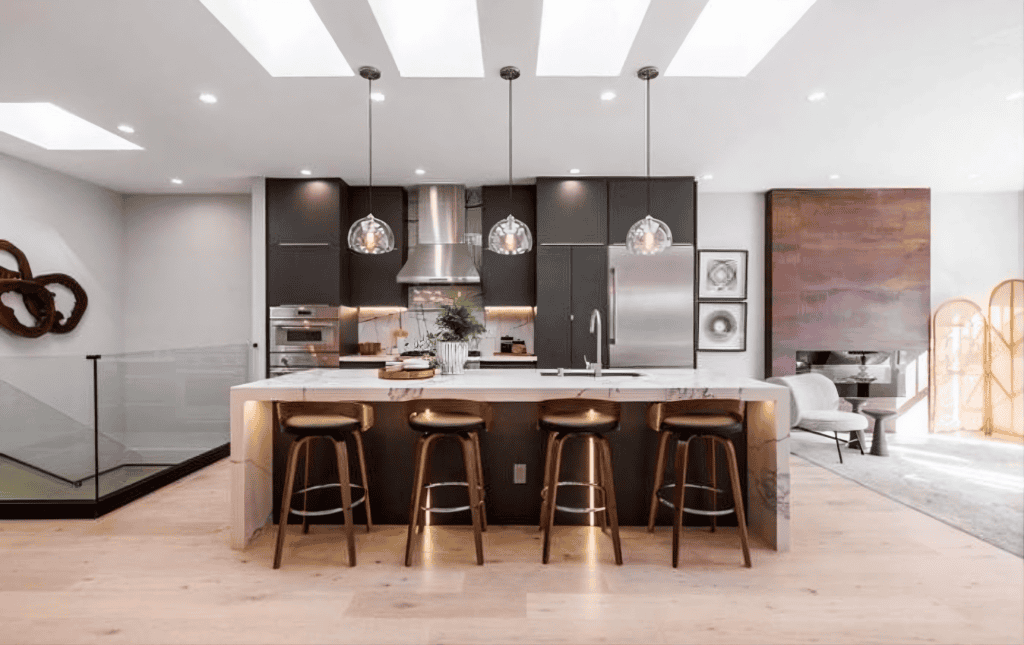 Modern kitchen with elegant lighting fixtures. by Ca by Builders