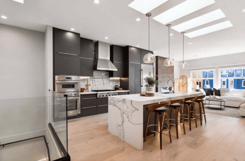Modern kitchen with island and seatingn by California bay builders
